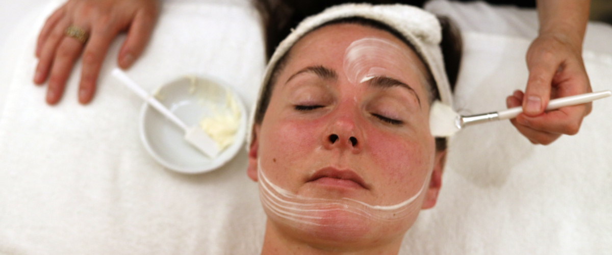 Spa Packages Bella Donna Spa Packages Woman receiving custom facial treatment.